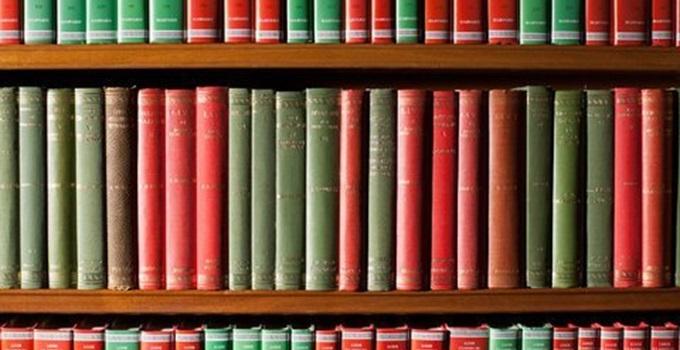 Multi-colored books on bookshelf